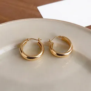 Elegant gold twisted hoop earrings with a minimalist crossed design for a premium look