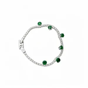 Elegant silver tennis bracelet featuring emerald green stones and a unique round clasp design.