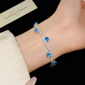 Close-up view of a silver bracelet featuring brilliant blue and white round zircons.