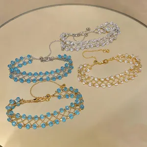 Detail of handmade hollowed-out beaded bracelets in blue and white colors