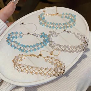 Detailed view of four handmade hollow mesh beaded bracelets in light blue and clear.