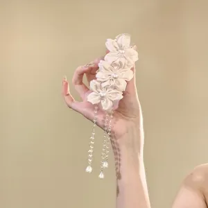 Elegant pink fabric flower hair clip with long pearl and crystal tassels detail