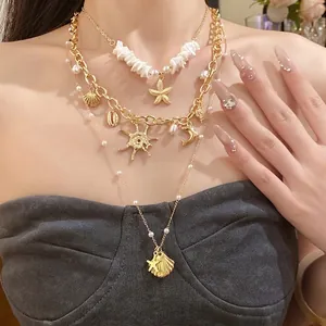 Squisita collana a strati con perle e ciondoli a stella marina per un elegante stile da spiaggia.
