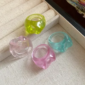 Macro view of colorful irregular resin rings set with transparent glossy finish