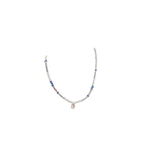 Elegant pearl necklace with blue beads and a square zircon pendant on white background.