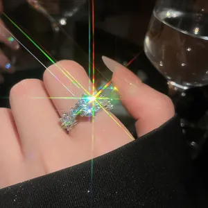 Close-up of French style sparkling zircon flower open ring with rainbow lens flare.