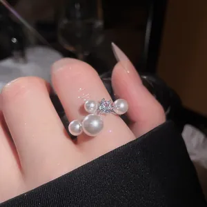 Detailed close-up of French vintage open ring with pearls and sparkling zircon