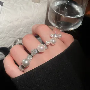 Close-up of French vintage open ring with shimmering zircons and elegant pearls.