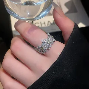 Elegant macro view of a vintage floral ring with sparkling micro-pave zircons on finger