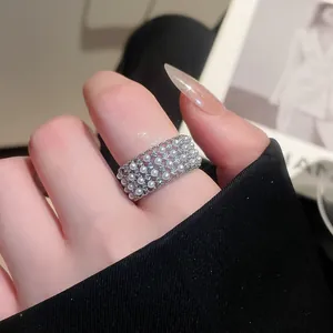 Close-up of a French vintage lattice ring with pearls and sparkling zircons on a finger