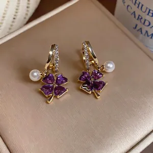 French elegant style pearl earrings featuring purple clover design and sparkling diamonds