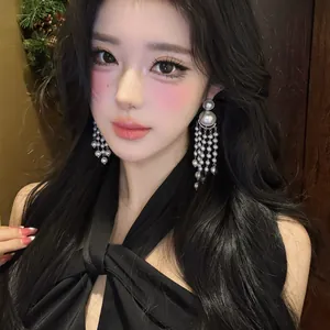 Close-up of model wearing elegant pearl tassel drop earrings in French retro style