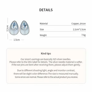 Macro view of light blue teardrop stud earrings with sparkling zircon inlay and product dimensions