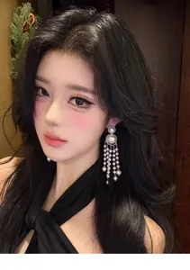 Elegant pearl fringe tassel earrings worn by Asian model in a close-up detail shot
