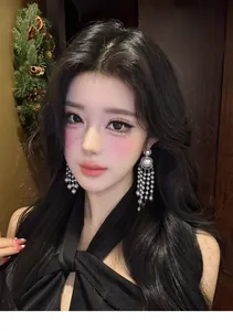 Detailed close-up showing elegant long pearl tassel drop earrings on an Asian female model
