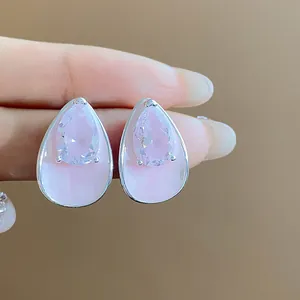 Detail view of pear-shaped earrings with pink enamel and sparkling zircon stone