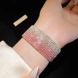 Close-up of elegant multi-layer pink gradient rhinestone elastic bracelet on wrist.