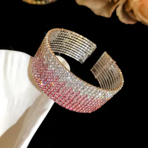 Detailed view of wide multi-row rhinestone elastic cuff bracelet with pink gradient