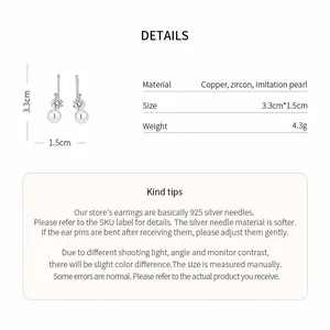 Close-up detail of elegant pearl earrings showing material and size specifications