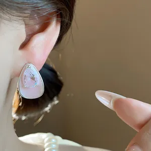 Close-up of pink drip oil water drop stud earring with a teardrop zircon crystal