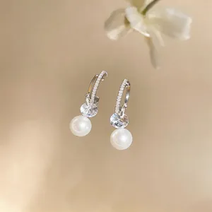 Elegant French style C-shape hoop earrings with cubic zirconia and white round pearls.