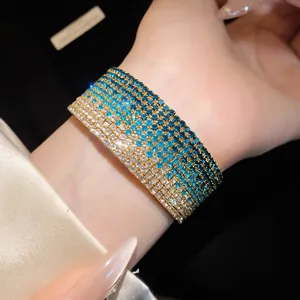 Close-up of a multi-row elastic bracelet with gradient blue and clear rhinestones.