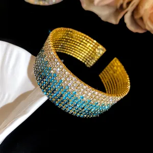 Close-up of a multi-layer gradient rhinestone elastic cuff bracelet in gold finish