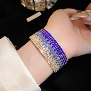 Macro detail of multi-layered gradient blue rhinestone bracelet with gold-tone setting