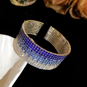 Detailed macro view of an elegant multi-layer gradient blue rhinestone open bangle