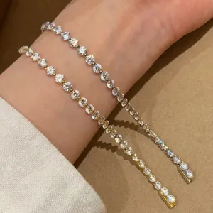Dettaglio macro che mostra lo splendore di due bracciali tennis in zircone indossati al polso.