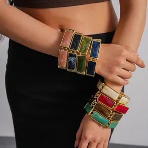 Macro view of vintage colorful rectangular resin tile stretch bracelets worn on a wrist