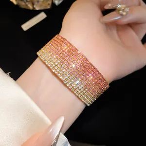 Close-up detail of a multi-layer gradient pink and white rhinestone elastic bracelet on wrist