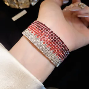 Close-up of multi-layer bracelet with red and white rhinestone gradient design