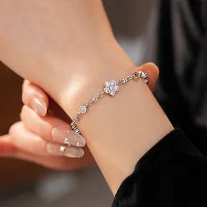 Elegant silver bracelet with sparkling cubic zirconia flower and round charms for women