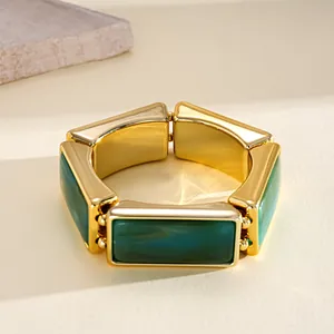 Detailed view of retro chunky bracelet with green resin blocks and gold-tone metal frame.