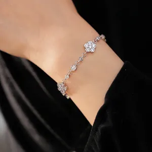 Elegant silver-toned cubic zirconia floral bracelet on wrist with black velvet backdrop