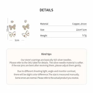 Detailed view of butterfly stud earrings with 14k gold plating and zircon inlay.