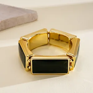 Close-up of retro chunky resin rectangular stretch bracelet in gold and dark green