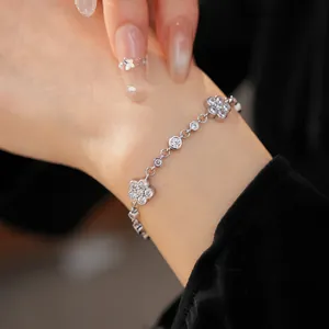Close-up detail of an elegant silver cubic zirconia flower bracelet worn on a woman's wrist