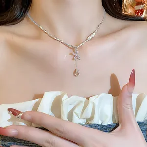 Close-up detail of a elegant zircon butterfly beaded necklace worn by a female model
