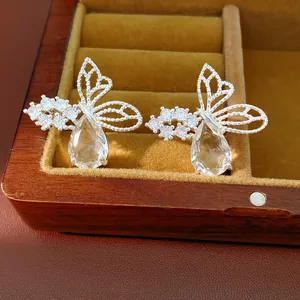 Detailed close-up view of elegant silver butterfly earrings with clear teardrop zircon drops.