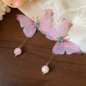 Detailed view of chiffon butterfly drop earrings with blue crystals and pink beads
