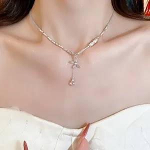 Detailed close-up of a silver butterfly necklace with zircon pendant and crystal drop