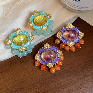 Elegant vintage oval resin earrings with crystal rhinestones and beads in turquoise and purple.