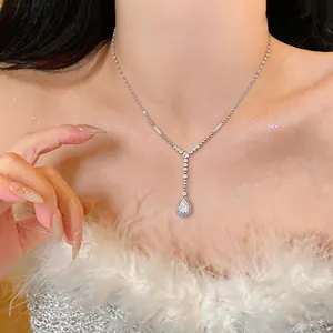 Close-up detail shot of an elegant silver teardrop zircon necklace worn by a model.