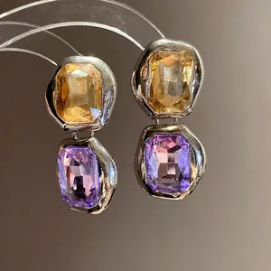 Elegant square gemstone drop earrings with yellow and purple crystals in silver frames.
