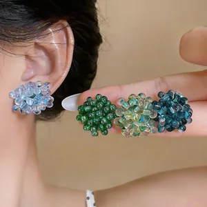 Detailed close-up view showing vibrant glass beaded flower earrings in multiple colors.