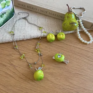 Detailed shot of forest style green apple jewelry set including necklace and earrings