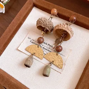 Vintage forest-style eucalyptus fruit drop earrings with wooden beads and unique metallic accents.