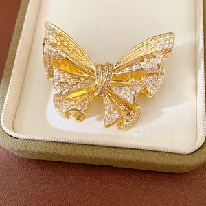 Detail view of 18k gold plated butterfly brooch with intricate crystal pavé setting
